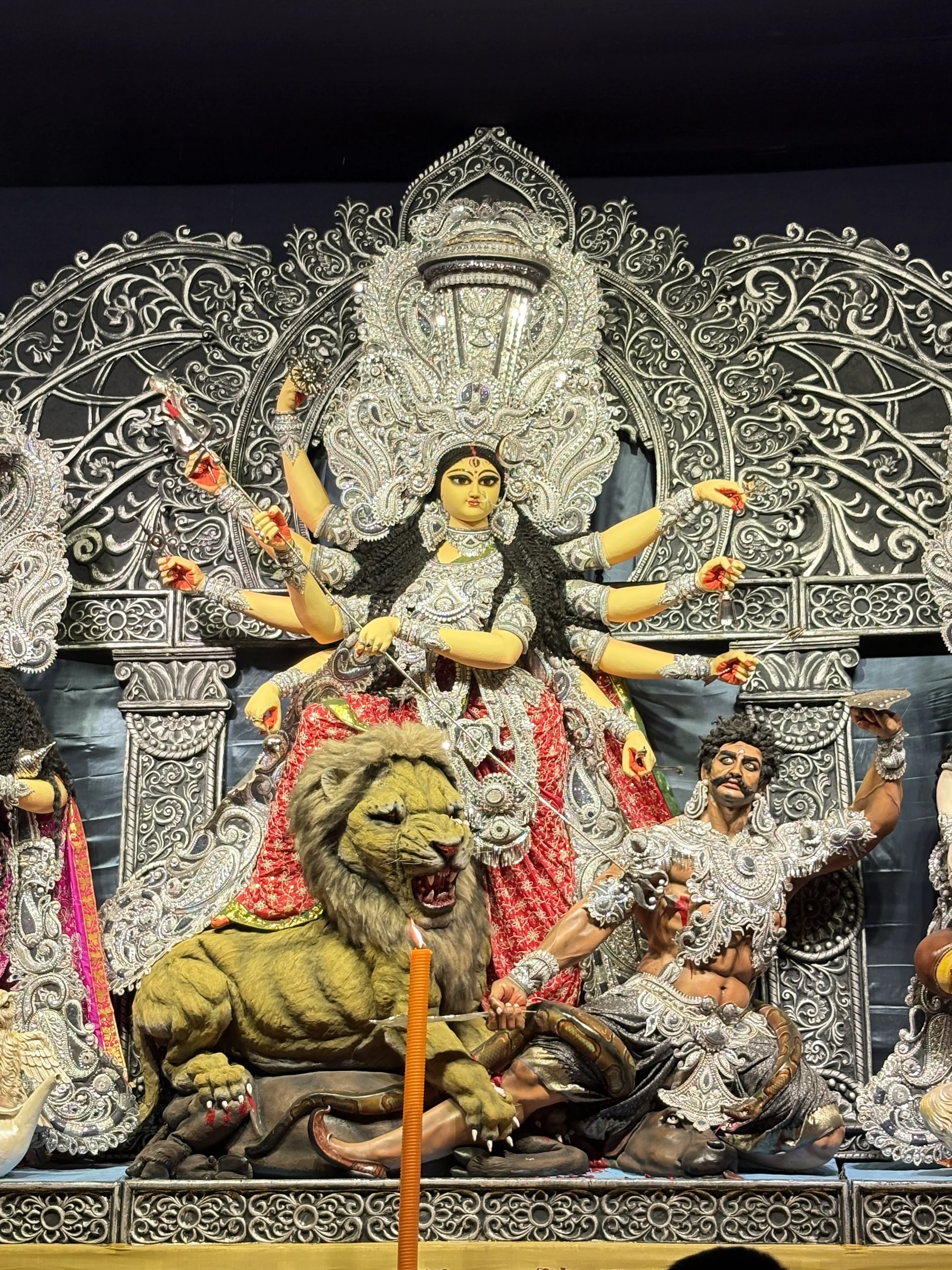 Durga idol framed by intricate silver detailing