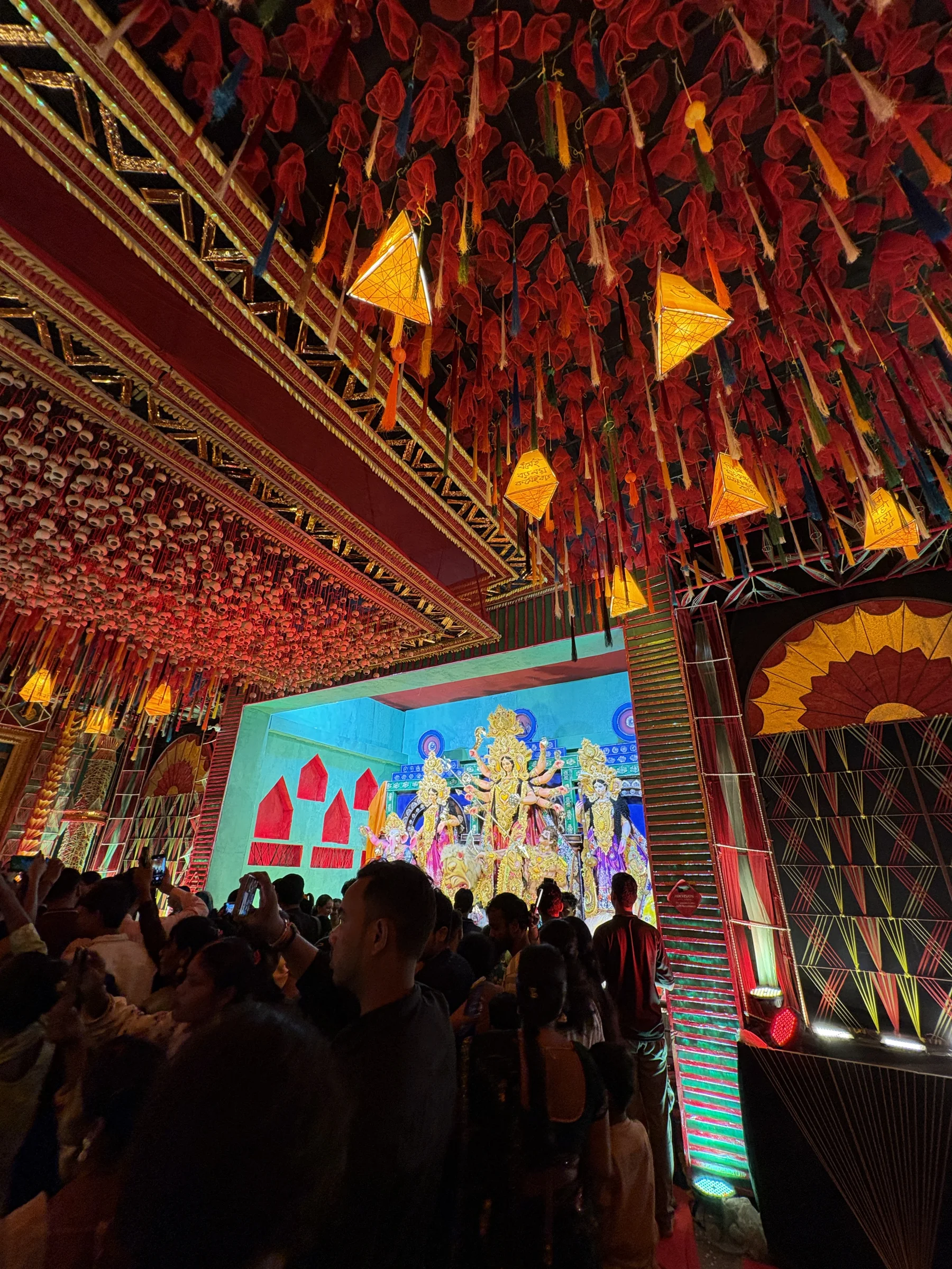 Red and amber decorations glowing above a festival crowd