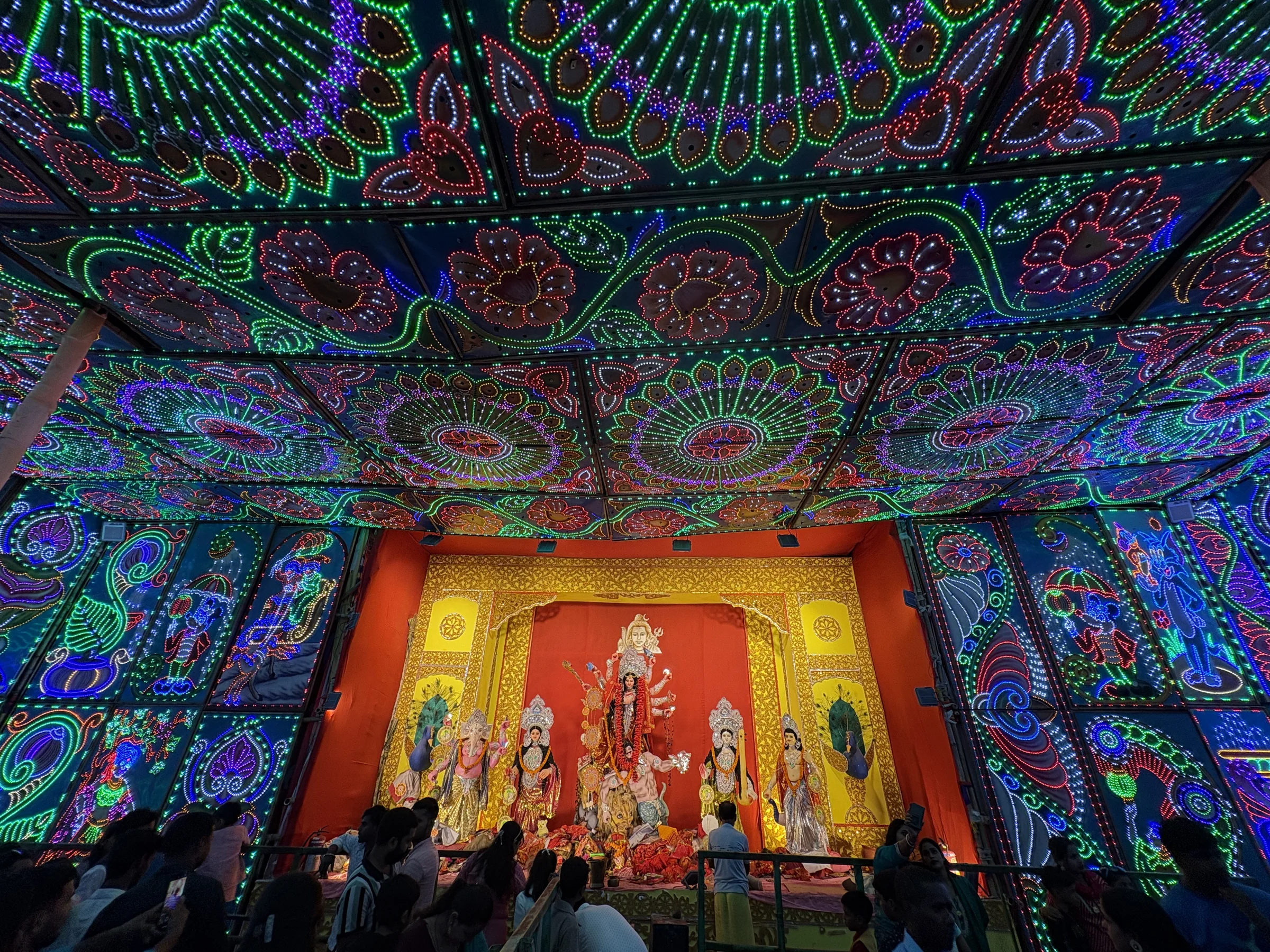 Colourful patterned lights over a Durga Puja pavilion