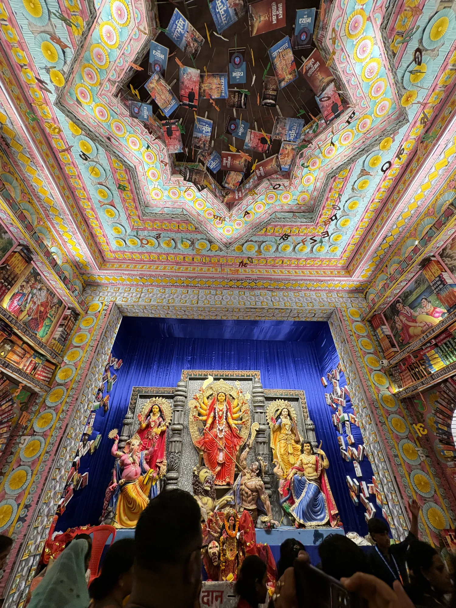 Colourful geometric ceiling inside a decorated pandal