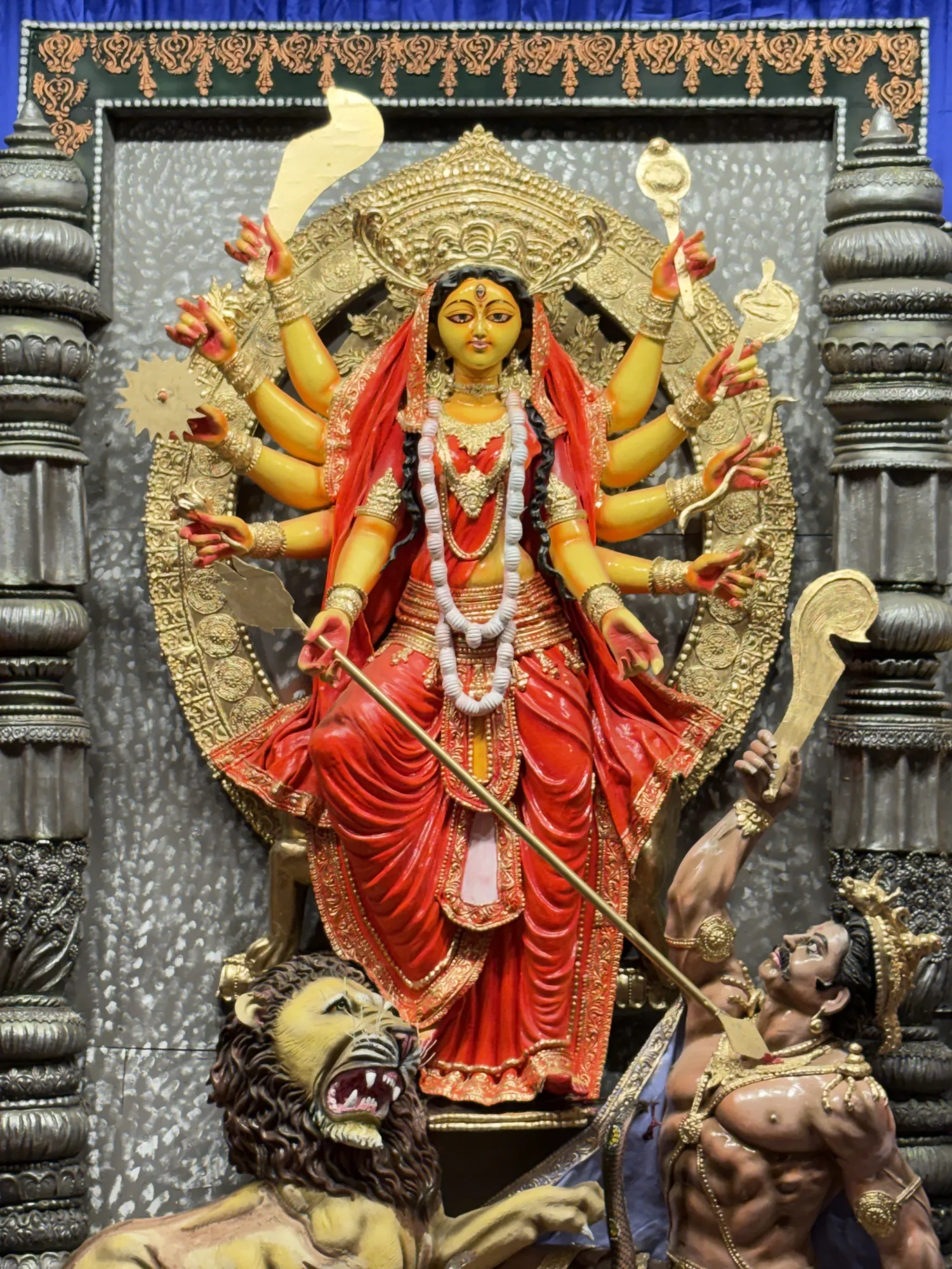 Close view of a Durga idol in red and gold